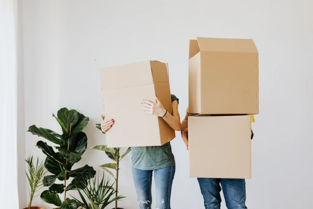 people holding boxes while moving home